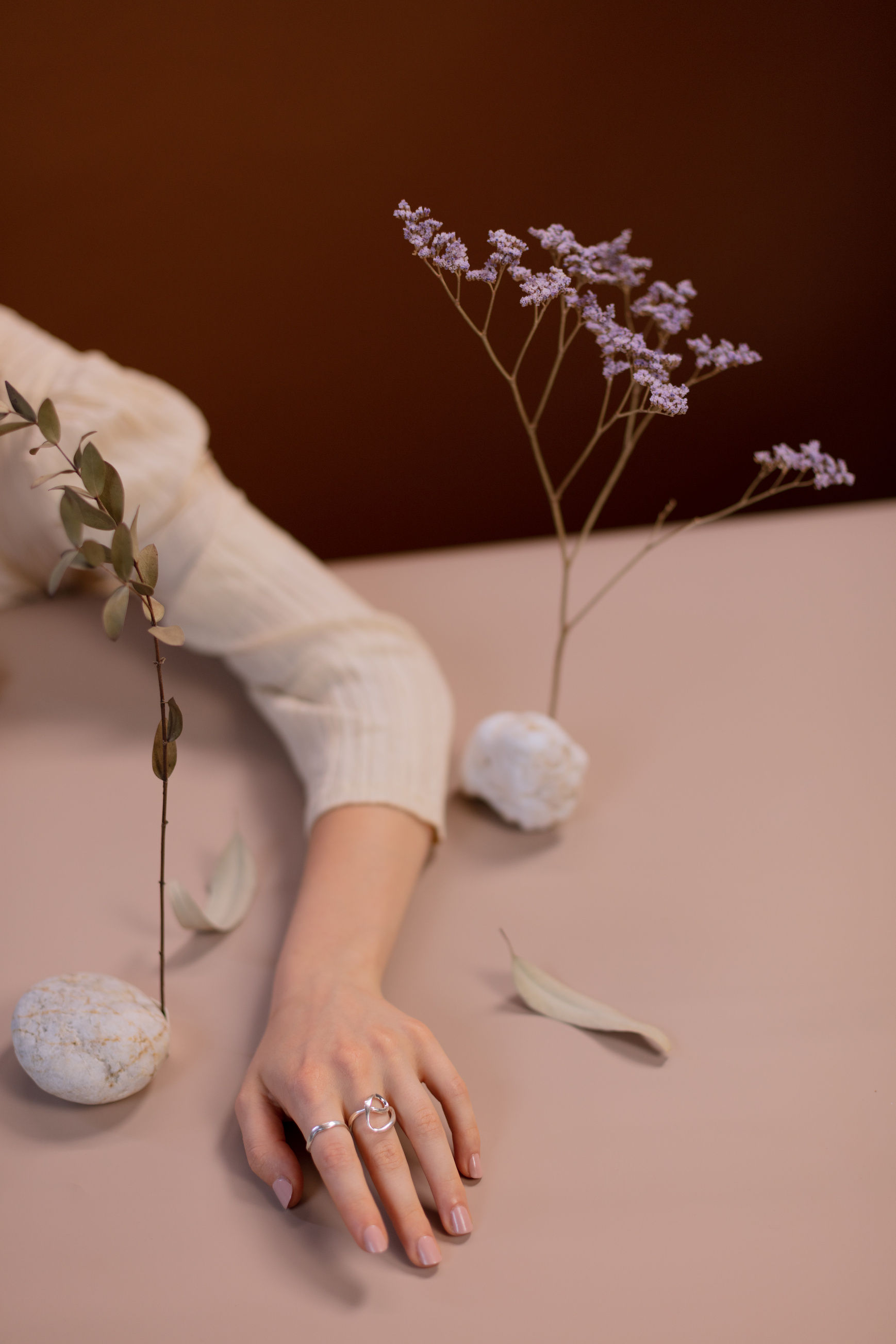 Person in White Long Sleeve Shirt Holding White Flowers